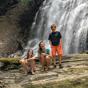 kids in front of waterfall